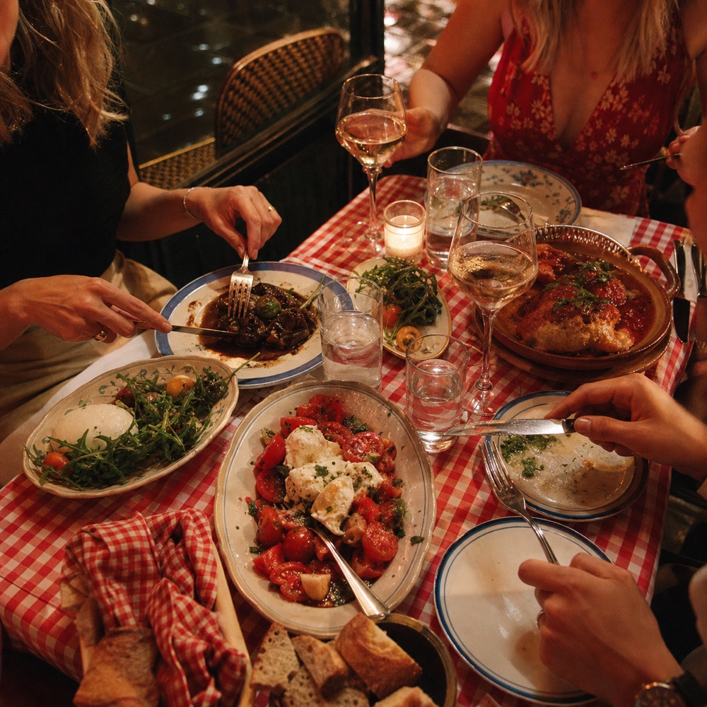 Friends sharing dinner at a checkered table
